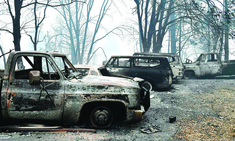 A row of burnt vehicles are pictured during the Creek fire in Auberry, Fresno County on September 11, 2020. - More than 20,000 firefighters from across the United States on Friday battled sprawling deadly wildfires up and down the West Coast -- a wave of infernos that have forced more than half a million people to flee their homes. (Photo by Frederic J. BROWN / AFP)