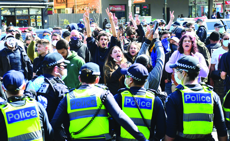 TOPSHOT - Anti-lockdown protesters chant slogans at Melbourne's Queen Victoria Market during a rally on September 13, 2020, amid the ongoing COVID-19 coronavirus pandemic. - Melbourne continues to enforce strict lockdown measures to battle a second wave of the coronavirus. (Photo by William WEST / AFP)