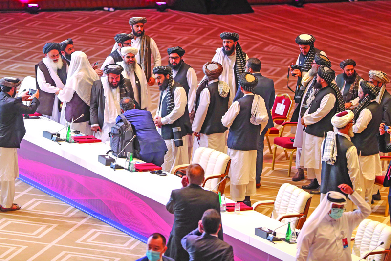 Members of the Taliban delegation leave their seats at the end of the session during the peace talks between the Afghan government and the Taliban in the Qatari capital Doha on September 12, 2020. (Photo by KARIM JAAFAR / AFP)