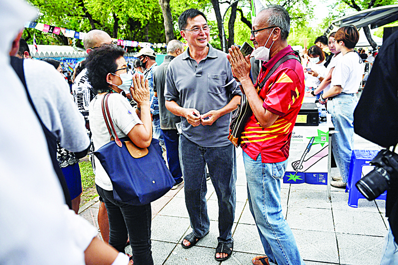 This photo taken on September 5, 2020 shows activist Somyot Prueksakasemsuk (C), who was jailed on lese majeste charges, speaking with fellow anti-government protesters during a student rally in Bangkok. - Jailed seven years for publishing satire of a fictitious royal family, activist Somyot Prueksakasemsuk is in awe today as university students spearhead a growing movement demanding reforms to Thailand's ultra-powerful monarchy. (Photo by Lillian SUWANRUMPHA / AFP) / To go with 'THAILAND-POLITICS-ROYALS,FOCUS' by Dene-Hern Chen and Pitcha Dangprasith