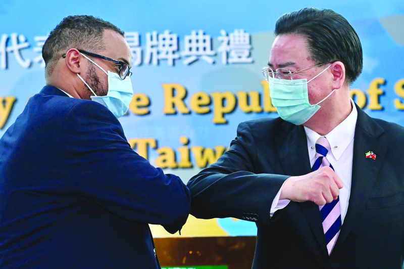 TAIPEI: Mohamed Hagi, Somaliland's Taiwan representative, bumps elbows with Taiwan's Foreign Minister Joseph Wu during the opening ceremony of the Somaliland representative office in Taipei yesterday. - AFP