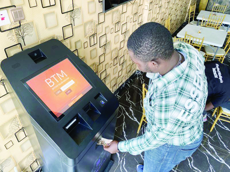 A bitcoin user buys bitcoins with naira on Bitcoin Teller Machine in Lagos