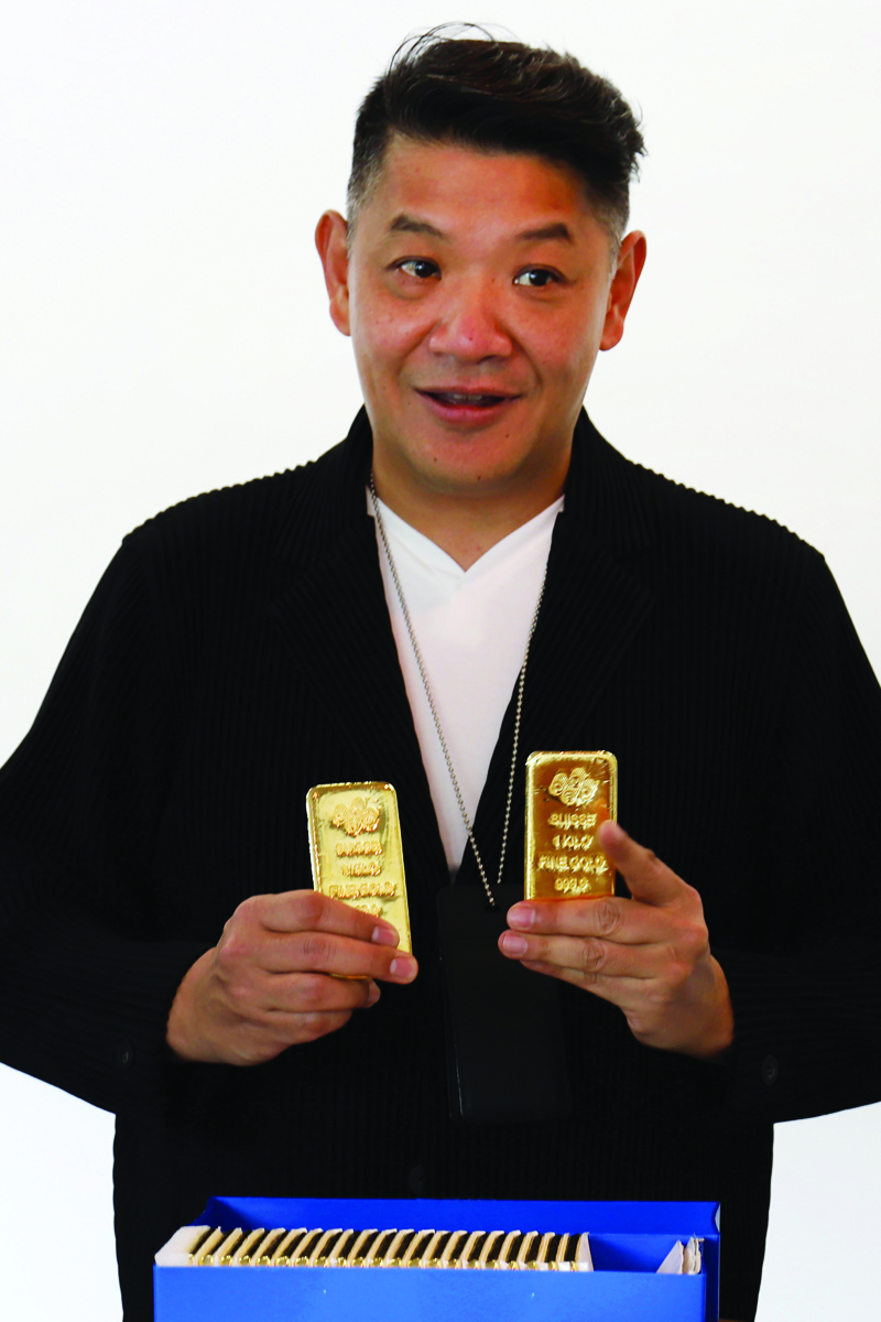 This photo taken on September 15, 2020 shows Victor Foo, chief executive of the Singapore Precious Metals Exchange (SGPMX), holding 1kg gold bars during a media tour at his office in Le Freeport, a private, maximum-security vault in Singapore. - With the coronavirus fuelling demand for safe-haven assets for investors to park their cash, a Singapore exchange is offering mom-and-pop investors what it says is an easier way to get their hands on the precious metal. (Photo by Martin ABBUGAO / AFP)