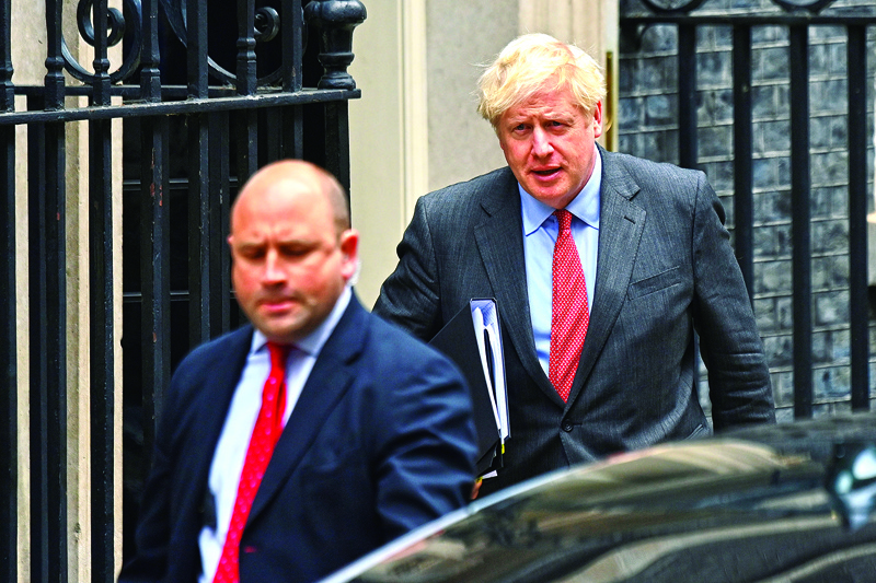 Britain's Prime Minister Boris Johnson leaves 10 Downing Street in central London on September 22, 2020 to make make a statement to MPs in Parliament on the COVID-19 pandemic. - The British government will announce fresh steps Tuesday to try and stop a coronavirus surge in England, while the United States was on the verge of 200,000 Covid-19 deaths. The pandemic is showing no signs of slowing down -- more than 31.2 million infections have been detected worldwide, with 964,000 deaths -- and nations are scrambling to contain new outbreaks. (Photo by JUSTIN TALLIS / AFP)
