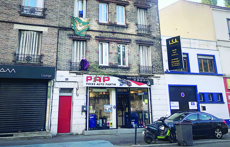 A picture taken on September 26, 2020 in Pantin, a suburb of Paris, shows the building, where one of the suspects who seriously wounded two people a day before in a terror attack, was living (first floor, two windows at the center right). - A man armed with a meat cleaver wounded two in Paris outside the former offices of satirical weekly Charlie Hebdo before being arrested by police, three weeks into the trial of suspected accomplices in the 2015 massacre of the newspaper's staff. (Photo by Wafaa ESSALHI / AFP)