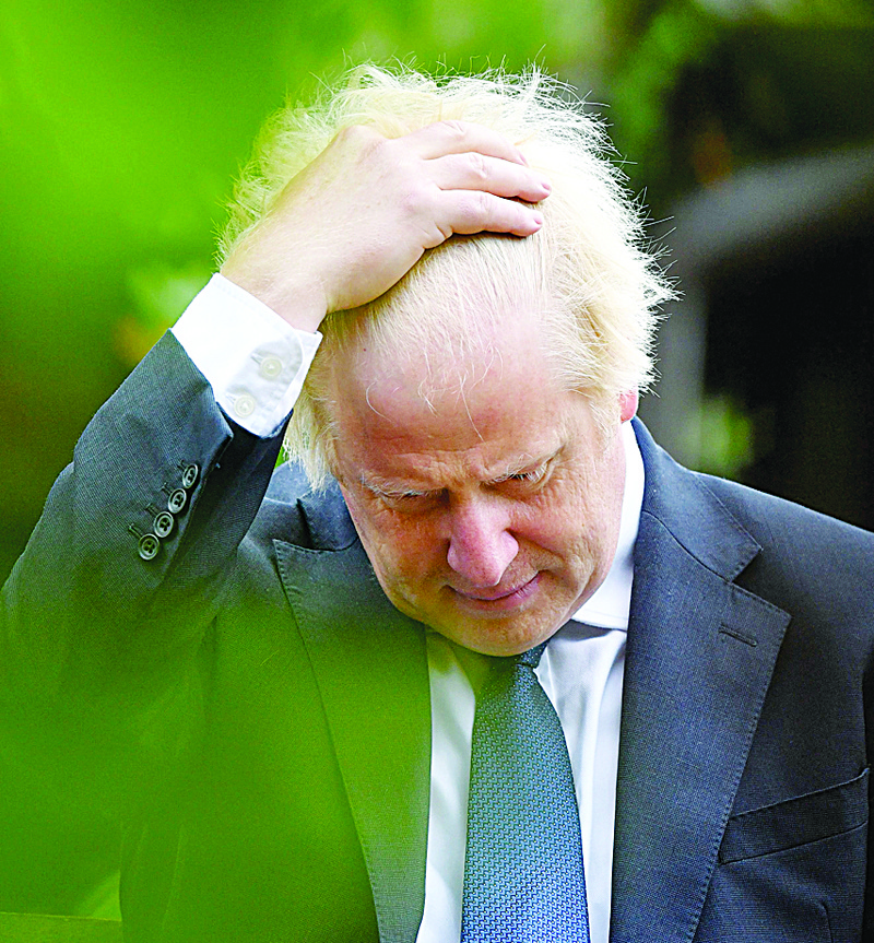 (FILES) In this file photo taken on August 15, 2020 Britain's Prime Minister Boris Johnson gestures as he attends a national service of remembrance at the National Memorial Arboretum in Alrewas, central England. - Boris Johnson, called  dejected and dogmatic even by his partisans, is enduring a torrid time in his tumultuous premiership, and worse may lie ahead. (Photo by Anthony Devlin / POOL / AFP)