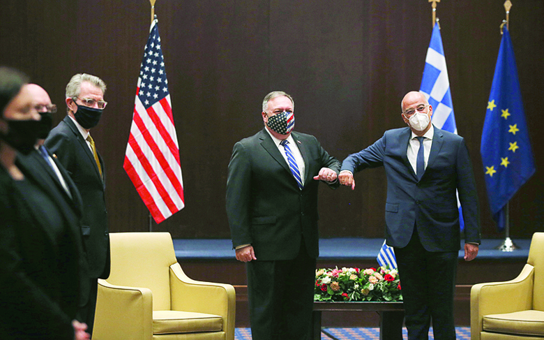 US Secretary of State Mike Pompeo (L) and Greek Foreign Minister Nikos Dendias touch elbows during their meeting in the northern city of Thessaloniki, on September 28, 2020. - Pompeo and Dendias will sign a bilateral science and technology agreement, as well as host energy sector business leaders for a discussion to highlight energy diversification and infrastructure projects in Greece. (Photo by Giannis Papanikos / POOL / AFP)
