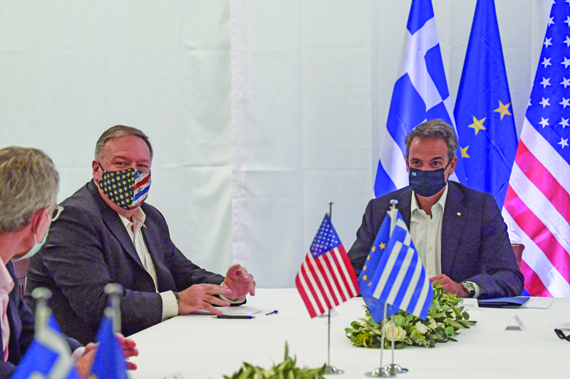 US Secretary of State Mike Pompeo (3RD L) and Greek Prime Minister Kyriakos Mitsotakis hold a meeting  during their visit to the Naval Support Activity base at Souda, the foremost US naval facility in the eastern Mediterranean on the Greek island of Crete. - US Secretary of State Mike Pompeo on September 29, 2020, concludes a two-day visit to Greece on with a tour of a strategically vital NATO base on a trip aimed at easing tensions between Greece and Turkey in the eastern Mediterranean. (Photo by ARIS MESSINIS / POOL / AFP)