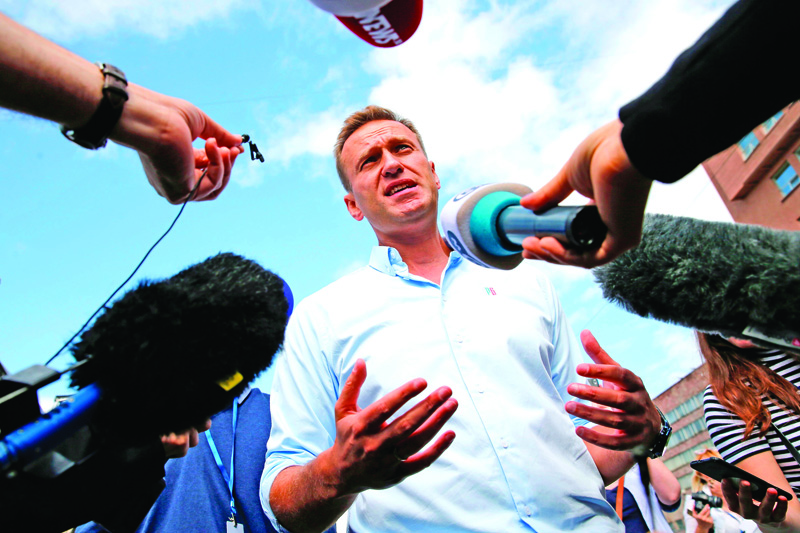 (FILES) This file photo taken on July 20, 2019 shows Russian opposition leader Alexei Navalny speaking with journalists during a rally to support opposition and independent candidates after authorities refused to register them for September elections to the Moscow City Duma, in Moscow. - Tests carried out on Russian opposition leader Alexei Navalny provide clear proof that he was poisoned by a chemical nerve agent, the German government said Wednesday, September 2, 2020, demanding explanations from Moscow. (Photo by Maxim ZMEYEV / AFP)