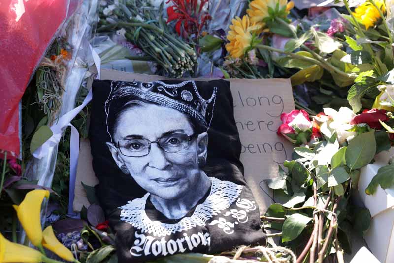 WASHINGTON, DC - SEPTEMBER 21: Signs and flowers are left at a makeshift memorial in front of the U.S. Supreme Court for the late Justice Ruth Bader Ginsburg September 21, 2020 in Washington, DC. Justice Ginsburg died last Friday from complications of pancreatic cancer at the age of 87.   Alex Wong/Getty Images/AFPn== FOR NEWSPAPERS, INTERNET, TELCOS &amp; TELEVISION USE ONLY ==