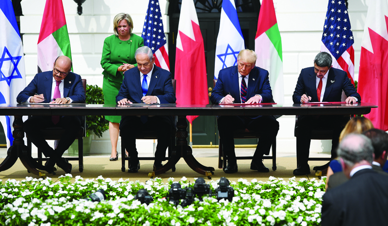 (L-R)Bahrain Foreign Minister Abdullatif al-Zayani, Israeli Prime Minister Benjamin Netanyahu, US President Donald Trump, and UAE Foreign Minister Abdullah bin Zayed Al-Nahyan participate in the signing of the Abraham Accords where the countries of Bahrain and the United Arab Emirates recognize Israel, at the White House in Washington, DC, September 15, 2020. - Israeli Prime Minister Benjamin Netanyahu and the foreign ministers of Bahrain and the United Arab Emirates arrived September 15, 2020 at the White House to sign historic accords normalizing ties between the Jewish and Arab states. (Photo by SAUL LOEB / AFP)