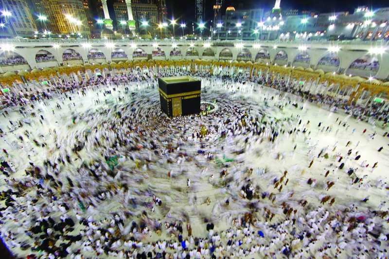 (FILES) In this file photo taken on June 14, 2018 Muslim worshippers gather at the Grand Mosque in Islam's holiest city of Mecca as Muslims perform the Umrah or lesser pilgrimages. - Saudi Arabia will gradually resume the year-round umrah pilgrimage for Muslims from October 4, the interior ministry said on September 23, 2020 seven months after it was suspended because of the coronavirus pandemic. (Photo by Bandar al-DANDANI / AFP)