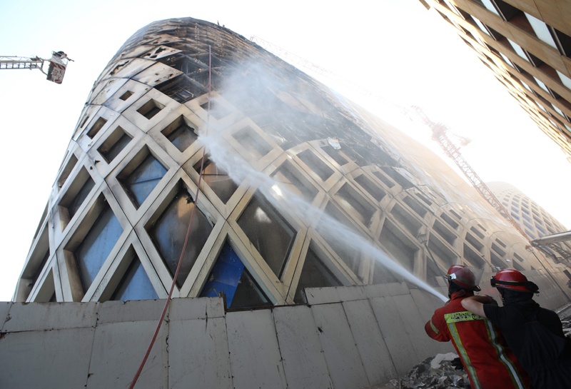 Lebanese firefighters douse the flames of a blaze that engulfed a landmark modern building, designed by the late world-renowned British-Iraqi architect Zaha Hadid, in central Beirut on September 15, 2020 - The reasons behind the fire, which comes one week after another one at a Beirut port warehouse containing food, were not immediately known. (Photo by ANWAR AMRO / AFP)