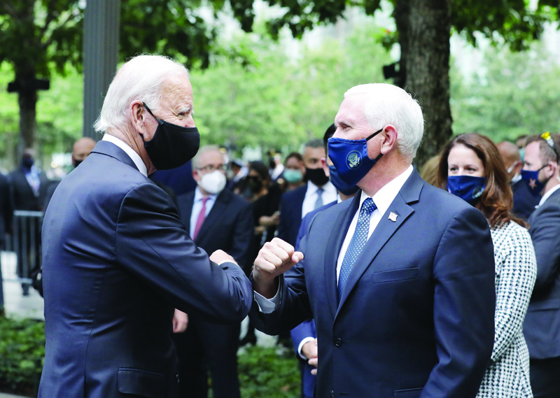 CORRECTION - Democratic Presidential Candidate Joe Biden (L) greets US Vice President Mike Pence as they attend a ceremony at the 9/11 Memorial in New York to commemorate the 19th anniversary of the 9/11 attacks, on September 11, 2020. (Photo by Angela Weiss / AFP) / ìThe erroneous mention[s] appearing in the metadata of this photo by Angela Weiss has been modified in AFP systems in the following manner: [New York] instead of [New Castle, Delaware]. Please immediately remove the erroneous mention[s] from all your online services and delete it (them) from your servers. If you have been authorized by AFP to distribute it (them) to third parties, please ensure that the same actions are carried out by them. Failure to promptly comply with these instructions will entail liability on your part for any continued or post notification usage. Therefore we thank you very much for all your attention and prompt action. We are sorry for the inconvenience this notification may cause and remain at your disposal for any further information you may require.î