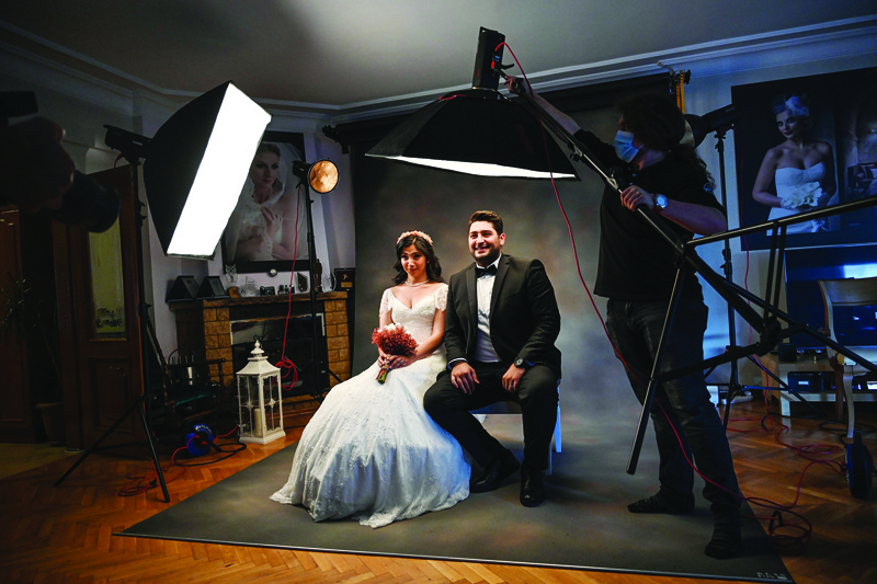 28-year-old Ayse Keles and her husband Alp Colak pose for a wedding photo shoot on September 5, 2020 in Istanbul. - Turkey has 600 000 weddings annually and contracts for their organisations are concluded months before and large sums are paid in advance. And in return, the gold coins, jewellery or money gifted to the couple during the lavish ceremonies help reduce their wedding debts. (Photo by Ozan KOSE / AFP)