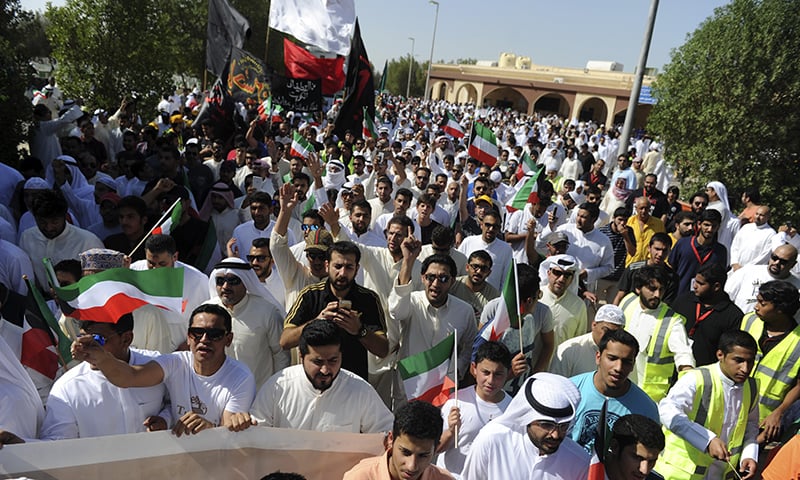 Thousands of Sunnis and Shiites from across the country take part in a mass funeral procession for 27 people killed in a suicide bombing that targeted the Shiite Imam Sadiq Mosque a day earlier, at the Grand Mosque in Kuwait City, Kuwait, Saturday, June 27, 2015. Police in Kuwait said they are interrogating a number of suspects with possible links to the bombing, which was claimed by an affiliate of the Islamic State group. (AP Photo)