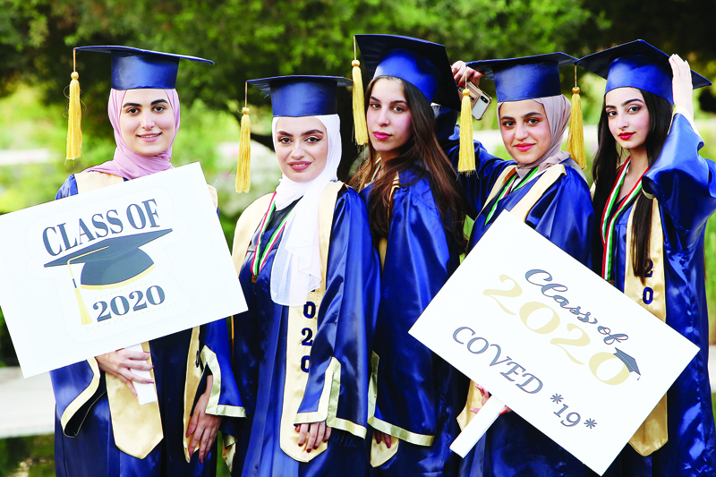 (R-L) Maya, Raghad, Yara, Jana and Fatima, Grade 12 high school students from Fajr Al-Sabah High School celebrate their graduation in their own way at the end of the school year in Kuwait City on September 18, 2020. The school year for grade 12 students ended after the school year resumed in August through online learning, due to the COVID-19 outbreak. High schools usually hold grand celebrations for their students after the end of the school year in Kuwait.