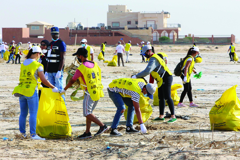 Participants clean trash on a beach in Kuwait City on September 19, 2020, to coincide with the World Cleanup Day. (Photo by YASSER AL-ZAYYAT / AFP)