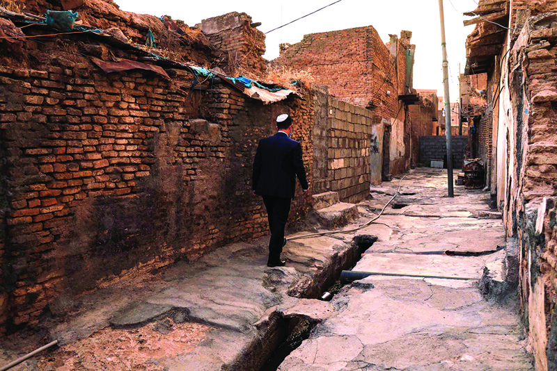 Ranj Abderrahman Cohen, an Iraqi Kurdish Jewish man, walks next to a ruined Jewish synagogue in Arbil, the capital of the autonomous Kurdish region of northern Iraq, on July 5, 2020. - Jews were historically Iraq's second-largest religious sect, comprising 40 percent of Baghdad's population according to a 1917 census. But since the creation of Israel in 1948, regional tensions skyrocketed and anti-Semitic campaigns took hold, pushing most of Iraq's Jews to flee. Today, Iraqis have fond memories of Jewish friends and neighbours, including 82-year-old Farhadi, whose father owned a shop in a Jewish-majority district of Arbil. (Photo by SAFIN HAMED / AFP)
