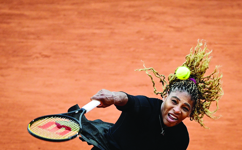 Serena Williams of the US serves the ball to Kristie Ahn of the US during their women's singles first round tennis match at the Philippe Chatrier court on Day 2 of The Roland Garros 2020 French Open tennis tournament in Paris on September 28, 2020. (Photo by MARTIN BUREAU / AFP)