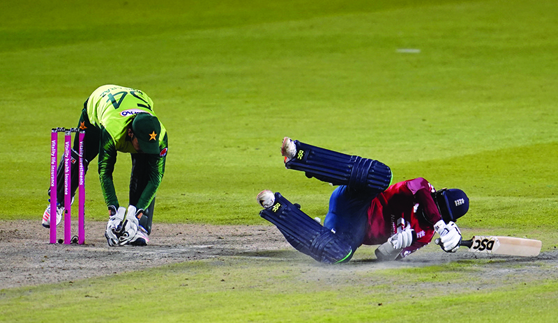 MANCHESTER: England’s Adil Rashid (R) makes his ground during the international Twenty20 cricket match between England and Pakistan at Old Trafford cricket ground in Manchester, north-west England. —AFP