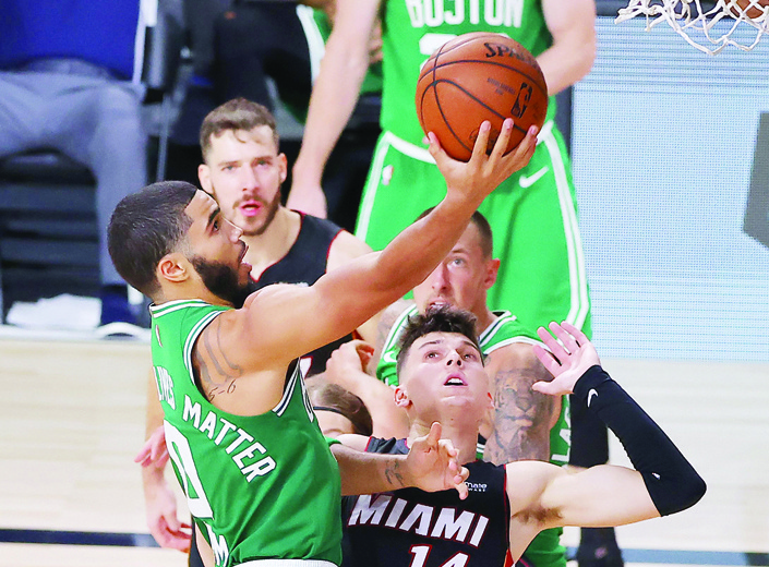 LAKE BUENA VISTA, FLORIDA - SEPTEMBER 19: Jayson Tatum #0 of the Boston Celtics drives to the basket against Tyler Herro #14 of the Miami Heat during the fourth quarter in Game Three of the Eastern Conference Finals during the 2020 NBA Playoffs at AdventHealth Arena at the ESPN Wide World Of Sports Complex on September 19, 2020 in Lake Buena Vista, Florida. NOTE TO USER: User expressly acknowledges and agrees that, by downloading and or using this photograph, User is consenting to the terms and conditions of the Getty Images License Agreement.   Kevin C. Cox/Getty Images/AFPn== FOR NEWSPAPERS, INTERNET, TELCOS &amp; TELEVISION USE ONLY ==