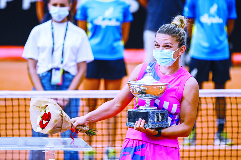 Romania's Simona Halep holds her trophy after winning the final match of the Women's Italian Open against Czech Republic's Karolina Pliskova, who pulled out following injury, at Foro Italico on September 21, 2020 in Rome, Italy. (Photo by Riccardo Antimiani / POOL / AFP)