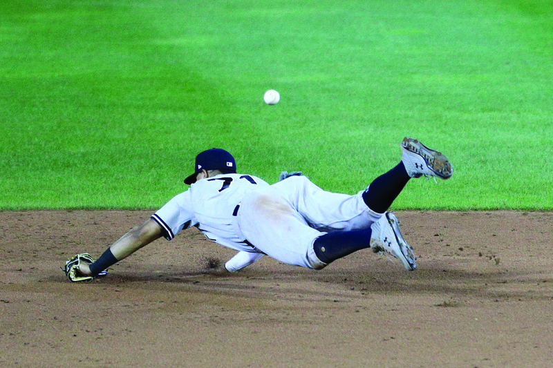 BUFFALO: Thairo Estrada #71 of the New York Yankees dives for a ball hit by Travis Shaw #6 of the Toronto Blue Jays during the sixth inning at Sahlen Field on September 07, 2020. - AFP