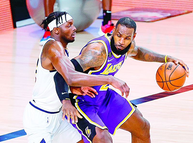 LeBron James #23 of the Los Angeles Lakers drives the ball against Jerami Grant #9 of the Denver Nuggets during the second quarter in Game Five of the Western Conference Finals during the 2020 NBA Playoffs at AdventHealth Arena at the ESPN Wide World Of Sports Complex on September 26, 2020 in Lake Buena Vista, Florida. - The Los Angeles Lakers, fueled by a triple-double from superstar LeBron James, beat the Denver Nuggets 117-107 on September 26 to reach the NBA Finals.nWith the win in the league's quarantine bubble in Orlando, Florida, the Lakers completed a 4-1 victory over the Nuggets in the best-of-seven Western Conference finals. (Photo by Kevin C. Cox / GETTY IMAGES NORTH AMERICA / AFP)