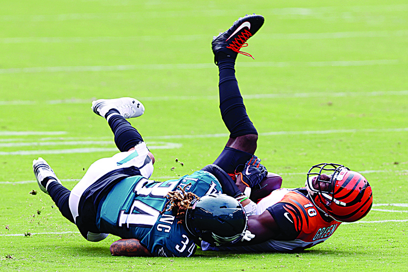 PHILADELPHIA, PENNSYLVANIA - SEPTEMBER 27: Cornerback Cre'von LeBlanc #34 of the Philadelphia Eagles tackles wide receiver A.J. Green #18 of the Cincinnati Bengals after a pass reception at Lincoln Financial Field on September 27, 2020 in Philadelphia, Pennsylvania.   Rob Carr/Getty Images/AFP