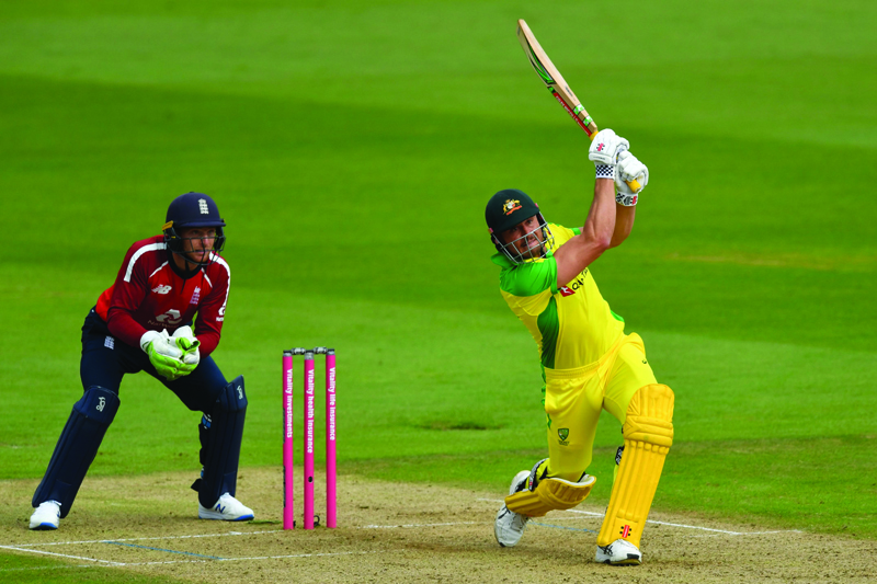 Australia's Marcus Stoinis (R) hits a six as England's Jos Buttler keeps wicket during the international Twenty20 cricket match between England and Australia at the Ageas Bowl in Southampton, southern nSOUTHAMPTON: Australia's Marcus Stoinis (right) hits a six as England's Jos Buttler keeps wicket during the international Twenty20 cricket match between England and Australia at the Ageas Bowl in Southampton on September 6, 2020. - AFP