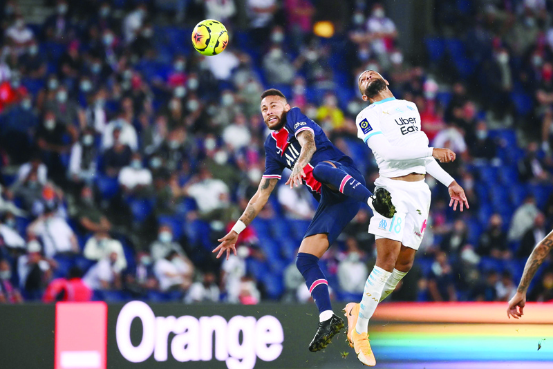 Marseille's French defender Jordan Amavi (R) and Paris Saint-Germain's Brazilian forward Neymar jump for the ball  during the French L1 football match between Paris Saint-Germain (PSG) and Marseille (OM) at the Parc de Princes stadium in Paris on September 13, 2020. (Photo by FRANCK FIFE / AFP)