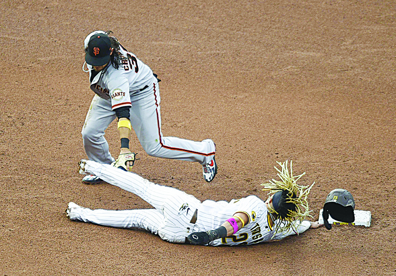 SAN DIEGO, CA - SEPTEMBER 13: Fernando Tatis Jr. #23 of the San Diego Padres is tagged out by Brandon Crawford #35 of the San Francisco Giants as he tries to get back to second base during the fifth inning of a baseball game at Petco Park on September 13, 2020 in San Diego, California. Today's game was to make up for Friday's postponed game.   Denis Poroy/Getty Images/AFPn== FOR NEWSPAPERS, INTERNET, TELCOS &amp; TELEVISION USE ONLY ==