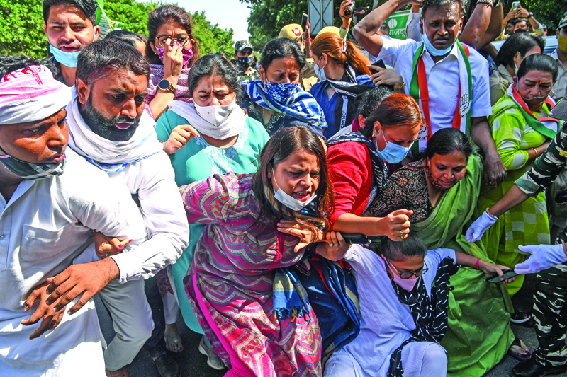 Congress supporters react as they face the police during a demonstration outside the Uttar Pradesh Bhawan (state house) in New Delhi on September 30, 2020, a day after a 19-year-old woman who was allegedly gang-raped died from her injuries near Bool Garhi village in the UP state. - Indian police were accused on September 30 of forcibly cremating the body of a 19-year-old alleged gang-rape victim as anger grew over the latest horrific sexual assault to rock the country. (Photo by Sajjad HUSSAIN / AFP)