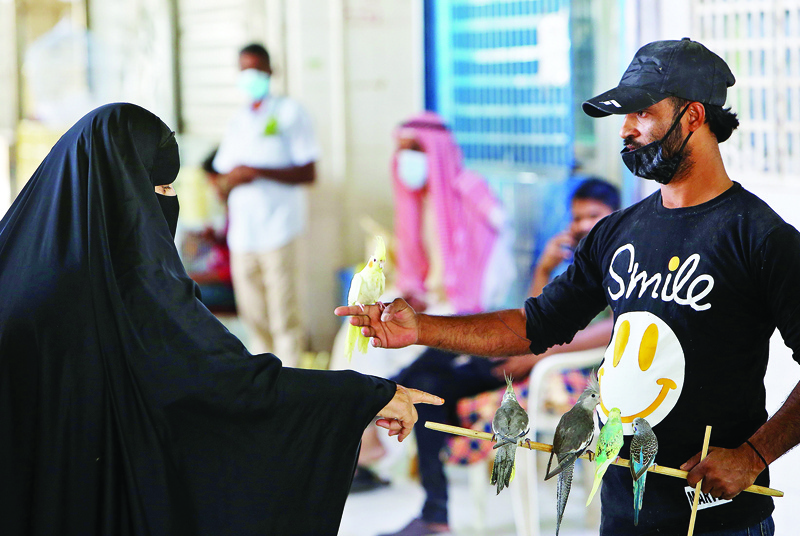 A Kuwaiti woman visits at the bird market in Kuwait City, on October 16, 2020. (Photo by YASSER AL-ZAYYAT / AFP)