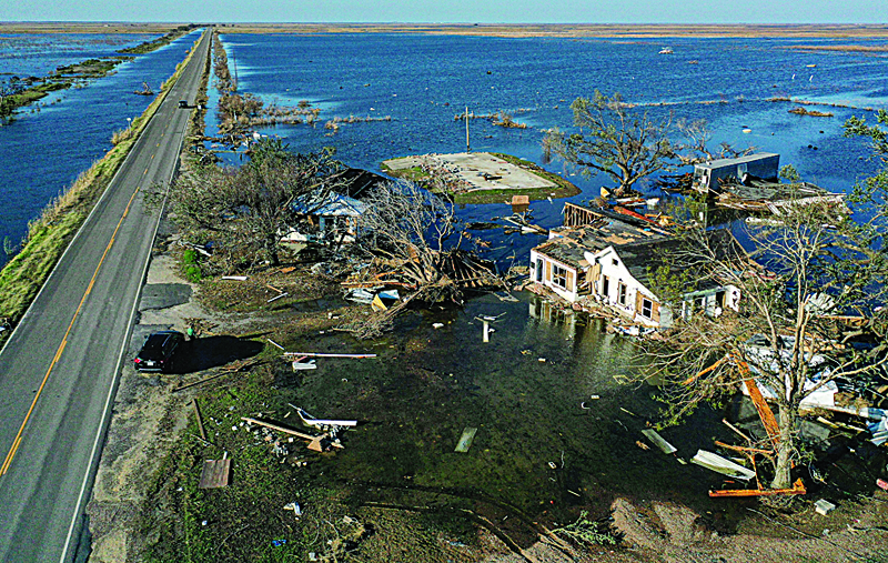 CREOLE, LOUISIANA - OCTOBER 10: An aerial view of flood waters from Hurricane Delta surrounding structures destroyed by Hurricane Laura (R) on October 10, 2020 in Creole, Louisiana. Hurricane Delta made landfall near Creole as a Category 2 storm in Louisiana initially leaving some 300,000 customers without power.   Mario Tama/Getty Images/AFPn== FOR NEWSPAPERS, INTERNET, TELCOS &amp; TELEVISION USE ONLY ==