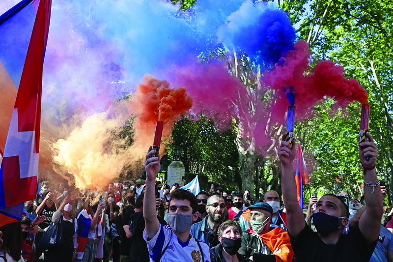 Members of the Armenian community march towards the Azerbaijan and Turkey Embassies in Buenos Aires, on October 10, 2020 during a protest in support of Armenia and Karabakh amid the territorial dispute with Azerbaijan over Nagorno Karabakh. (Photo by ALEJANDRO PAGNI / AFP)