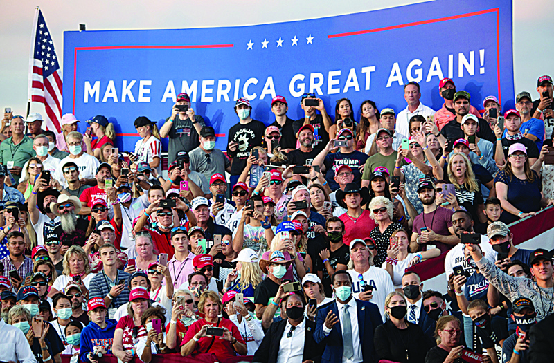 Supporters of US President Donald Trump attend a Make America Great Again rally as he campaigns at Orlando Sanford International Airport in Sanford, Florida, October 12, 2020. (Photo by SAUL LOEB / AFP)