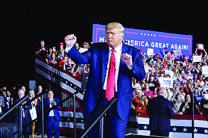 TOPSHOT - US President Donald Trump dances at the end of a campaign rally at Pensacola International Airport in Pensacola, Florida on October 23, 2020. (Photo by MANDEL NGAN / AFP)
