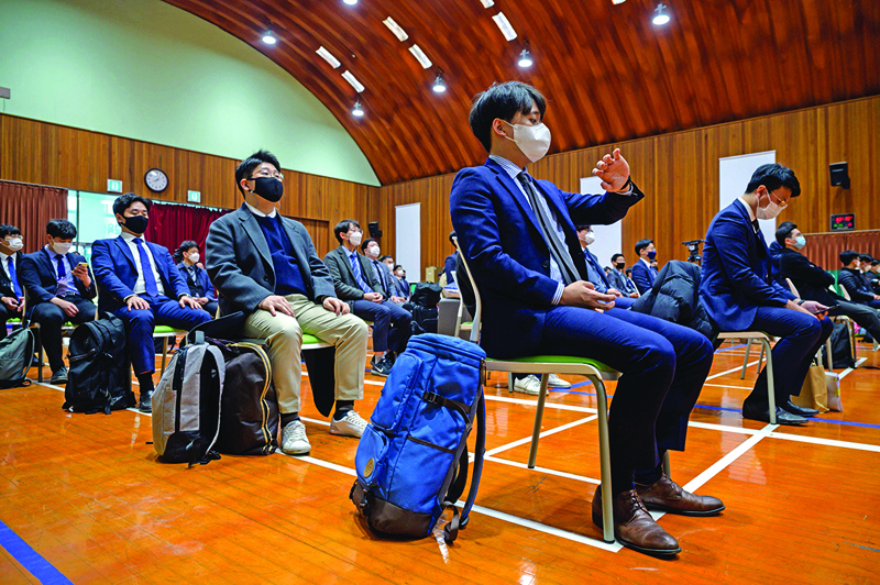 South Korean Jehovah's Witnesses who are conscientious objectors to mandatory military service, await an induction session at a correctional facility where they will begin training as adminstrators, in Daejeon on October 26, 2020. - A new scheme for those who object to bearing arms on religious or moral grounds went into effect, requiring them to work as prison adminstrators for three years -- twice the length of normal conscription. (Photo by Ed JONES / AFP)