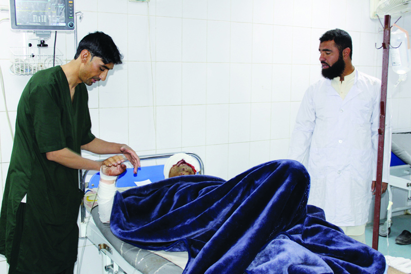 A wounded man receives medical treatment at a hospital after a car bomb attack on an Afghan police base in Khost province on October 27, 2020. - A car bomb attack on an Afghan police base followed by an ongoing gun battle have killed two policemen and wounded dozens of people in a city bordering Pakistan, officials said on October 27. (Photo by FARID ZAHIR / AFP)