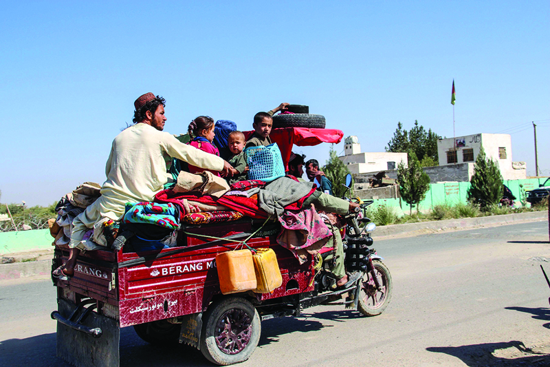 Internally displaced people with their belongings flee from Nadali district to Lashkar Gah during the ongoing clashes between Taliban fighters and Afghan security forces, in Helmand province on October 14, 2020. - Tens of thousands of people in southern Afghanistan have fled their homes following days of heavy fighting between the Taliban and security forces, officials said on October 14, as violence continues to soar despite ongoing peace talks. (Photo by - / AFP)