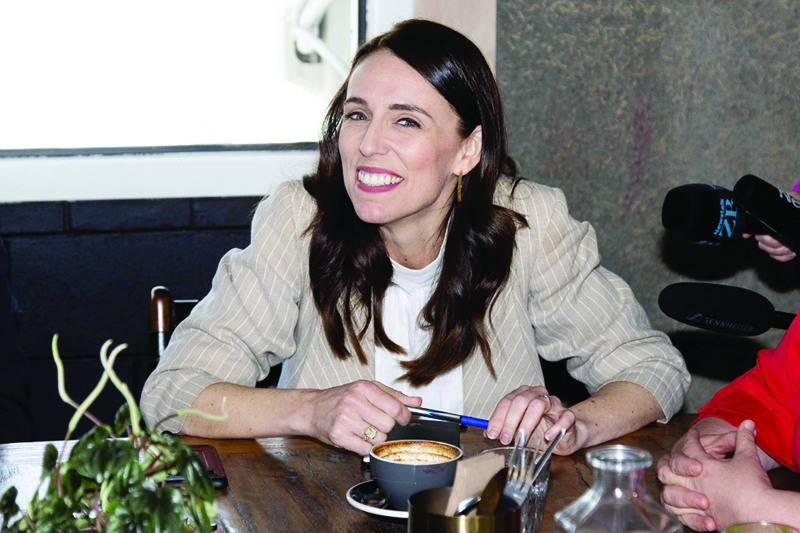 New Zealand Prime Minister Jacinda Ardern speaks with senior members of parliament a day after her landslide election win, in Auckland on October 18, 2020. (Photo by Marty MELVILLE / AFP)