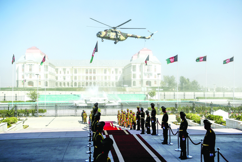 An Afghan Air Force helicopter flies over ahead of the arrival of Afghanistan's President Ashraf Ghani for the introduction of ministerial nominees at the Parliament in Kabul on October 21, 2020. (Photo by WAKIL KOHSAR / AFP)