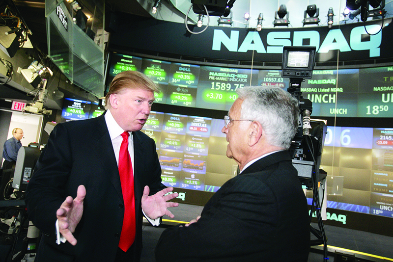 NEW YORK: Donald Trump speaks with Frank Zarb, former CEO of the Nasdaq Stock Market, in this file photo. —AFP