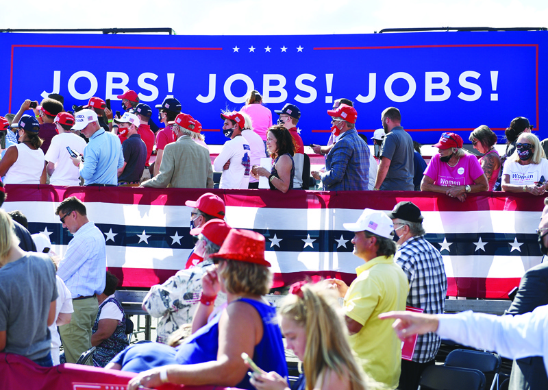 (FILES) In this file photo taken on August 17, 2020, supporters listen as US President Donald Trump delivers remarks on the economy at at an airport hanger in Oshkosh, Wisconsin. - The United States added a less-than-expected 661,000 jobs in September but the unemployment rate fell to 7.9 percent, the Labor Department said Friday, underscoring the economy's tortured recovery from Covid-19. (Photo by Brendan Smialowski / AFP)