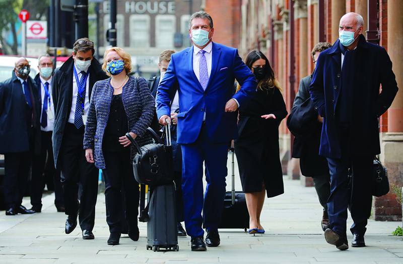 European Commission vice president Maros Sefcovic (C) wearing a face mask or covering due to the COVID-19 pandemic, prepares to enter London St Pancras station in London on October 19, 2020. - Britain still wants to reach a post-Brexit trade deal with the European Union despite the current deadlock, a senior government minister insisted ahead of fresh talks Monday. The UK had imposed a deadline of last week's EU summit for a deal, and Prime Minister Boris Johnson said he was ready to walk away and prepare for a no-deal exit after five decades of EU membership. (Photo by Tolga AKMEN / AFP) / ìThe erroneous mention[s] appearing in the metadata of this photo by Tolga AKMEN has been modified in AFP systems in the following manner: [prepares to enter London St Pancras station in London on October 19, 2020.] instead of [after arriving in London]. Please immediately remove the erroneous mention[s] from all your online services and delete it (them) from your servers. If you have been authorized by AFP to distribute it (them) to third parties, please ensure that the same actions are carried out by them. Failure to promptly comply with these instructions will entail liability on your part for any continued or post notification usage. Therefore we thank you very much for all your attention and prompt action. We are sorry for the inconvenience this notification may cause and remain at your disposal for any further information you may require.î
