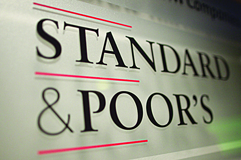 epa03028011 A sign displays the name of Standard &amp; Poor's financial rating services in its offices in Paris, France, 08 December 2011. On 05 December, Standard &amp; Poor's placed the EU AAA credit rating on credit watch, warning it may downgrade the euro-zone countries if a solution Europe's debt crisis during was not agreed on.  EPA/IAN LANGSDON