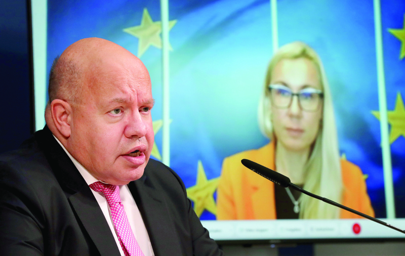German Economy Minister, Peter Altmaier (L) and European Commissioner for Energy Kadri Simson (On screen) address the media after a virtual meeting of the European energy ministers on October 6, 2020 in Berlin. (Photo by Michael Sohn / POOL / AFP)
