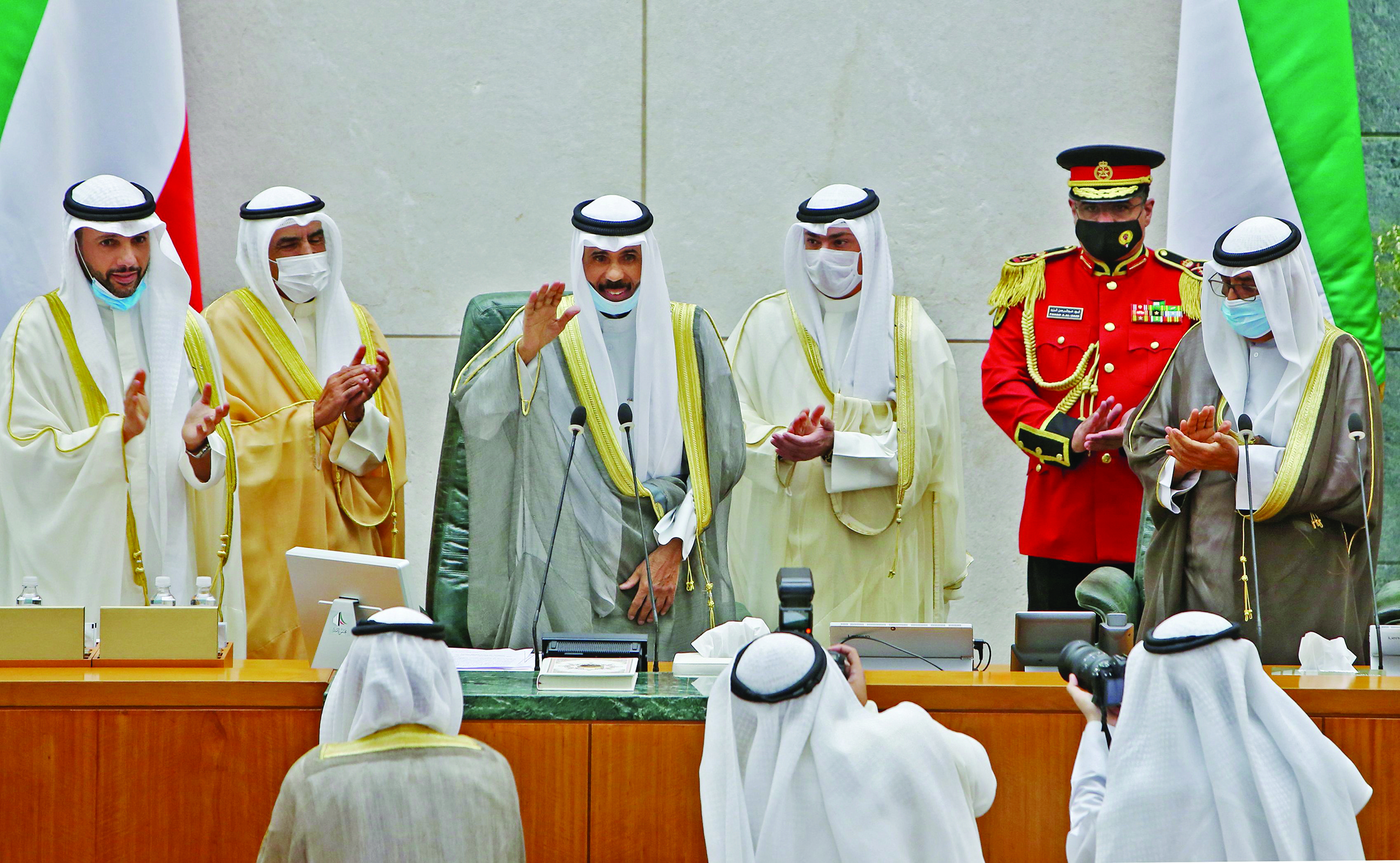 Emir of Kuwait Sheikh Nawaf al-Ahmad al-Jaber al-Sabah (C) gestures in greeting as he arrives with Crown Prince Sheikh Meshal al-Ahmad al-Jaber al-Sabah (R) and Parliament Speaker Marzouq al-Ghanim (L) to attend the opening of the 5th regular session at the country's National Assembly (parliament) in Kuwait City on October 20, 2020. (Photo by YASSER AL-ZAYYAT / AFP)